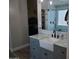 Modern bathroom with gray vanity, farmhouse sink, and walk-in shower at 28677 N Roselite Ln, San Tan Valley, AZ 85143