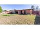 House exterior and expansive backyard with grassy area at 3020 E Des Moines St, Mesa, AZ 85213