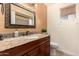 Bathroom boasts granite countertop, updated vanity, and decorative mirror at 3020 E Des Moines St, Mesa, AZ 85213