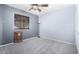 Simple bedroom with ceiling fan and window at 3020 E Des Moines St, Mesa, AZ 85213
