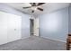 Bright bedroom with ceiling fan and double closet at 3020 E Des Moines St, Mesa, AZ 85213