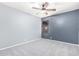 Spacious bedroom with ceiling fan and window at 3020 E Des Moines St, Mesa, AZ 85213