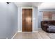 Interior entryway with tile flooring and wooden door at 3020 E Des Moines St, Mesa, AZ 85213