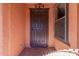 Dark brown front door with decorative hardware at 3020 E Des Moines St, Mesa, AZ 85213