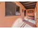 Covered patio with stone flooring and wrought iron details at 3020 E Des Moines St, Mesa, AZ 85213