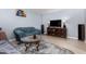 Living room with tiled floor, sofa, and TV at 3020 E Des Moines St, Mesa, AZ 85213