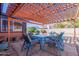 Relaxing patio area with pergola and outdoor dining set at 3020 E Des Moines St, Mesa, AZ 85213