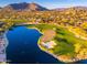 Aerial view of golf course with lake and mountains at 32427 N 71St Way, Scottsdale, AZ 85266