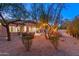 Peaceful backyard with desert landscaping, string lights, and a charming water feature at 32427 N 71St Way, Scottsdale, AZ 85266