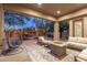 Relaxing backyard patio with fire pit, seating area, and water fountain at 32427 N 71St Way, Scottsdale, AZ 85266