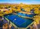 Well-lit tennis courts with mountain backdrop at 32427 N 71St Way, Scottsdale, AZ 85266