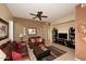 Living room with leather furniture, entertainment center, and ceiling fan at 3722 N Sonoran Hls, Mesa, AZ 85207