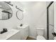 Modern bathroom with double vanity, large mirror, and walk-in shower at 5138 E Holly St, Phoenix, AZ 85008