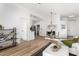 Living and dining area with wood-look flooring, white walls, and access to the kitchen at 7006 E Jensen St # 111, Mesa, AZ 85207