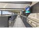 Modern outdoor kitchen with stainless steel appliances and bar seating at 7180 E Kierland Blvd # 311, Scottsdale, AZ 85254