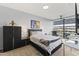 Bright bedroom with a queen bed, large window, and city views at 7180 E Kierland Blvd # 311, Scottsdale, AZ 85254