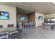 Well-equipped outdoor kitchen with bar seating and TVs at 7180 E Kierland Blvd # 311, Scottsdale, AZ 85254