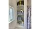 Well-lit bathroom with linen shelves and marble shower at 7750 E Broadway Rd # 911, Mesa, AZ 85208