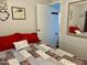 Spacious bedroom with ensuite bathroom access and red accents at 7750 E Broadway Rd # 911, Mesa, AZ 85208