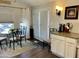 Cozy dining area adjacent to kitchen with glass table and iron chairs at 7750 E Broadway Rd # 911, Mesa, AZ 85208