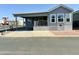 Gray manufactured home with covered carport and small yard at 7750 E Broadway Rd # 911, Mesa, AZ 85208