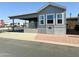 Gray manufactured home with covered carport and small yard at 7750 E Broadway Rd # 911, Mesa, AZ 85208