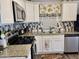 White kitchen cabinets, granite countertops, and stainless steel appliances at 7750 E Broadway Rd # 911, Mesa, AZ 85208