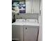 Laundry area with washer, dryer, and overhead cabinets at 7750 E Broadway Rd # 911, Mesa, AZ 85208