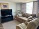 Spacious living room with a brown couch and recliner at 7750 E Broadway Rd # 911, Mesa, AZ 85208