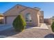 Tan house with a round turret and a two-car garage at 1083 W Kachina Dr, Coolidge, AZ 85128