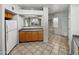 Bright kitchen with ample counter space, wood cabinets, and white appliances at 1351 N Pleasant Dr # 2079, Chandler, AZ 85225