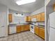 Kitchen featuring ample counter space, essential appliances, and light wood cabinetry at 1351 N Pleasant Dr # 2079, Chandler, AZ 85225