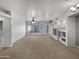 Spacious living room with plush carpet and built-in shelving at 1351 N Pleasant Dr # 2079, Chandler, AZ 85225