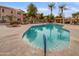 Community pool with lounge chairs and surrounding palm trees at 1351 N Pleasant Dr # 2079, Chandler, AZ 85225