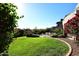 Landscaped backyard oasis with lush greenery and sparkling pool at 13631 E Windrose Dr, Scottsdale, AZ 85259