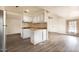 Bright kitchen featuring white cabinetry, wood-look flooring, and an open layout to the dining area at 151 S 39Th St, Mesa, AZ 85206