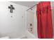 Bathroom featuring a tub and red shower curtain at 16080 W Maricopa St, Goodyear, AZ 85338