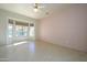 Spacious bedroom with tile flooring and a ceiling fan at 20229 N Sundance Way, Surprise, AZ 85374