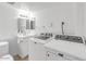 Bathroom with white vanity, toilet and stacked washer/dryer at 2040 S Longmore -- # 68, Mesa, AZ 85202