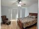 Main bedroom with wood floors and sliding glass door at 2101 S Meridian Rd # 421, Apache Junction, AZ 85120