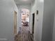 Hallway with wood-look flooring offering views into the kitchen at 2101 S Meridian Rd # 421, Apache Junction, AZ 85120