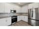 Modern white kitchen with stainless steel appliances at 2129 E Voltaire Ave, Phoenix, AZ 85032