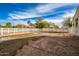 Muddy backyard with white fence and puddles at 21406 E Mewes N Rd, Queen Creek, AZ 85142