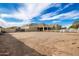 Large dirt backyard with a white fence and a view of the back of a two-story house at 21406 E Mewes N Rd, Queen Creek, AZ 85142