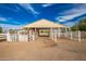 Horse barn with white fencing and dirt ground at 21406 E Mewes N Rd, Queen Creek, AZ 85142