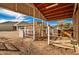 Interior view of barn with stalls, fencing, and hay at 21406 E Mewes N Rd, Queen Creek, AZ 85142