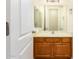 Bathroom with single sink vanity and wooden cabinets at 21406 E Mewes N Rd, Queen Creek, AZ 85142