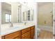 Bathroom with double sink vanity, shower and tub, and wood-look flooring at 21406 E Mewes N Rd, Queen Creek, AZ 85142