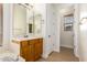View of bathroom vanity, adjacent room entrance, and wood-look flooring at 21406 E Mewes N Rd, Queen Creek, AZ 85142