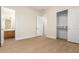Empty bedroom with wood-look flooring, walk-in closet, and attached bathroom at 21406 E Mewes N Rd, Queen Creek, AZ 85142